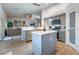 Open kitchen featuring an island with bar seating, modern appliances, gray cabinets, and a pantry at 2144 Paganini Ave, Henderson, NV 89052