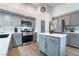 Well-equipped kitchen with stainless steel appliances, an island, gray cabinets, and a walk-in pantry at 2144 Paganini Ave, Henderson, NV 89052