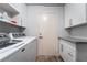 Well-organized laundry room with modern washer and dryer, ample cabinets, and sleek countertops at 2144 Paganini Ave, Henderson, NV 89052
