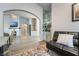 Open-concept living room featuring hardwood floors, a fireplace, and a built-in bar with mirrored shelves at 2144 Paganini Ave, Henderson, NV 89052