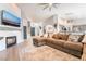 Open-concept living space featuring a modern fireplace, a cozy sofa, and seamless flow into the kitchen at 2144 Paganini Ave, Henderson, NV 89052