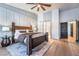 Elegant main bedroom featuring wood floors, a king-size bed, an ensuite bathroom, and walk-in closets at 2144 Paganini Ave, Henderson, NV 89052