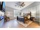 Spacious main bedroom featuring a large bed, wood floors, natural lighting, and a mounted TV at 2144 Paganini Ave, Henderson, NV 89052
