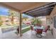 Relaxing backyard featuring a covered patio with seating, a sparkling pool, and well-maintained landscaping at 2144 Paganini Ave, Henderson, NV 89052