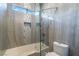 Modern shower-tub combo with glass doors, and tiled walls at 2144 Paganini Ave, Henderson, NV 89052