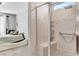 Handicap accessible bathroom with tiled walk-in shower, a grab bar and a built-in bench at 2395 Dalewood Ave, North Las Vegas, NV 89086