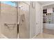 Handicap accessible bathroom featuring a tiled walk-in shower and a view into the walk-in closet at 2395 Dalewood Ave, North Las Vegas, NV 89086