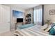 Comfortable bedroom features a modern decor, a bright window and modern curtains at 2395 Dalewood Ave, North Las Vegas, NV 89086