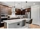 Modern kitchen with dark cabinets, stainless steel appliances, quartz countertops and island with seating at 2395 Dalewood Ave, North Las Vegas, NV 89086