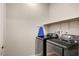 Laundry room with a washer, dryer, and shelf at 2395 Dalewood Ave, North Las Vegas, NV 89086