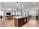 Open-concept living area boasts hardwood floors, modern lighting, and a seamless flow into the dining space at 2395 Dalewood Ave, North Las Vegas, NV 89086