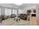 Open-concept living space with hardwood floors, leading into modern kitchen at 2395 Dalewood Ave, North Las Vegas, NV 89086