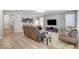 Open-concept living area with hardwood floors leading into kitchen at 2395 Dalewood Ave, North Las Vegas, NV 89086