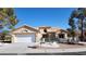 Single story home with a two-car garage and landscaped yard at 2904 Bow Bridge Dr, Las Vegas, NV 89134