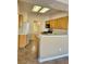 View of kitchen with light wood cabinets, tile floor, and access to laundry at 2905 Faiss Dr, Las Vegas, NV 89134