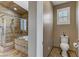 Bathroom featuring wood floors, a shower with glass door, toilet, and cabinet in neutral colors at 3906 Jacob Lake Cir, Las Vegas, NV 89118