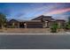 Gorgeous single-story home featuring a three-car garage, brick driveway, and desert landscaping at 3906 Jacob Lake Cir, Las Vegas, NV 89118