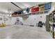 Spacious garage featuring epoxy flooring, overhead storage, and a fridge at 3906 Jacob Lake Cir, Las Vegas, NV 89118