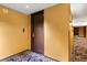 Hotel-style hallway with dark brown doors and yellow walls at 4381 W Flamingo Rd # 17318, Las Vegas, NV 89103