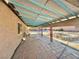 Tiled back patio has large covered area, view of stone landscape wall, and lush garden at 5132 Springland St, Las Vegas, NV 89146