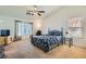 Main bedroom with ceiling fan and floral bedding at 5302 Azure View Ct, North Las Vegas, NV 89031