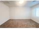 Simple bedroom with neutral wall and carpet, and a window with blinds at 629 Soaring Wings Ave, Las Vegas, NV 89183