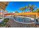 Inviting kidney-shaped pool with safety fence and BBQ grill at 8608 Alfano Ct, Las Vegas, NV 89117