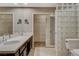 Bathroom featuring dual sinks, a large mirror, walk-in closet, toilet, and tile flooring at 8805 Litchfield Ave, Las Vegas, NV 89134
