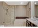 Bathroom featuring a walk-in shower, soaking tub, vanity with sink, tile flooring, and linen closet at 8805 Litchfield Ave, Las Vegas, NV 89134