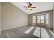 Bedroom with vaulted ceilings, neutral walls, carpet, ceiling fan, and bay windows for natural light at 8805 Litchfield Ave, Las Vegas, NV 89134