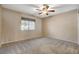 Neutral bedroom features carpet, window, and ceiling fan at 8805 Litchfield Ave, Las Vegas, NV 89134