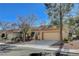 Street view of home showcasing the garages, front yard, and desert landscaping at 8805 Litchfield Ave, Las Vegas, NV 89134
