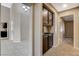 Hallway featuring built-in cabinets, tile and carpet flooring, access to the kitchen, and other rooms at 8805 Litchfield Ave, Las Vegas, NV 89134
