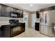 Modern kitchen with stainless steel appliances and dark wood cabinets at 8805 Litchfield Ave, Las Vegas, NV 89134