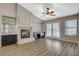 Living room showcases a cozy fireplace, ceiling fan, and bar area, with natural light from the french doors at 8805 Litchfield Ave, Las Vegas, NV 89134