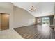Bright living room featuring wood floors, vaulted ceilings, a modern chandelier, and large windows at 8805 Litchfield Ave, Las Vegas, NV 89134