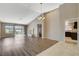 Bright living room featuring wood floors, a fireplace, vaulted ceilings, and sliding glass doors at 8805 Litchfield Ave, Las Vegas, NV 89134
