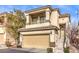 Two-story townhome with tan exterior, attached garage, and balcony at 9742 Darlington Ct, Las Vegas, NV 89149