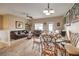 Open living and dining area with leather sofas and a glass dining table at 9742 Darlington Ct, Las Vegas, NV 89149