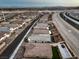 Aerial view of community with homes and a highway nearby at 10185 Sequoia Falls Pl, Las Vegas, NV 89149