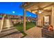 Landscaped backyard with patio, artificial turf, and built-in grill at 10185 Sequoia Falls Pl, Las Vegas, NV 89149