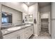 Double vanity bathroom with granite countertops and large mirror at 10185 Sequoia Falls Pl, Las Vegas, NV 89149