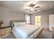 Main bedroom with ceiling fan, large bed, and ensuite bathroom access at 10185 Sequoia Falls Pl, Las Vegas, NV 89149