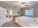 Spacious bedroom with ceiling fan, large bed, and access to the bathroom at 10185 Sequoia Falls Pl, Las Vegas, NV 89149