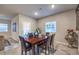 Bright dining room features a wood table with six chairs and large window at 10185 Sequoia Falls Pl, Las Vegas, NV 89149