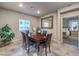 Formal dining room with wood table, six chairs, and large mirror at 10185 Sequoia Falls Pl, Las Vegas, NV 89149