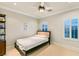 Bright bedroom with a queen-size bed and plantation shutters at 10308 Rocky Mesa Ct, Las Vegas, NV 89144