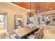 Bright dining room with chandelier, large table and views into the living room at 10308 Rocky Mesa Ct, Las Vegas, NV 89144