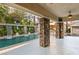 Covered patio area with stone columns overlooking the pool and fountain at 10308 Rocky Mesa Ct, Las Vegas, NV 89144