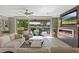 Bright living room showcasing a modern fireplace and access to a backyard oasis with a pool at 1221 Olivia Pkwy, Henderson, NV 89011